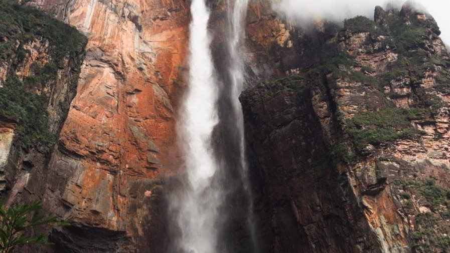 Angel Falls in Venezuela seen from the Mirador Laime viewpoint, its narrow stream dropping from the cliff edge of Auyán-tepui into a mist-filled gorge