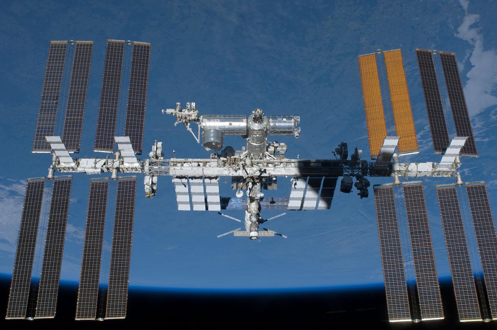 The International Space Station photographed against Earth during a shuttle flyaround in 2011, the same station now scheduled to be deorbited near Point Nemo in 2031