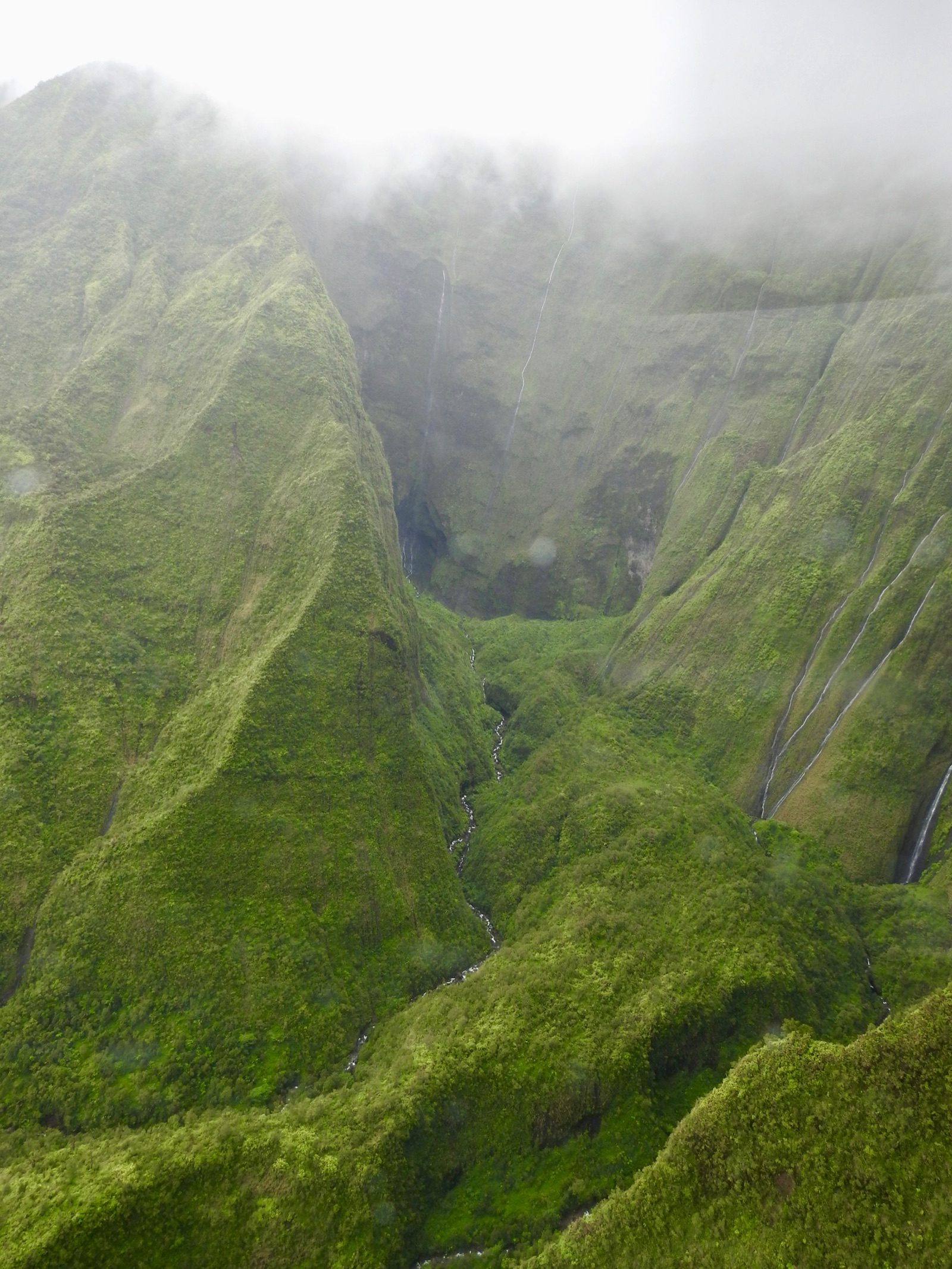 Waterfalls cascading from the rain-soaked caldera rim of Mount Waialeale on the Hawaiian island of Kauai